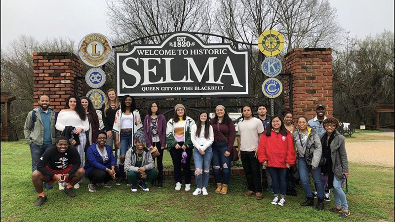 Students pose with Selma sign