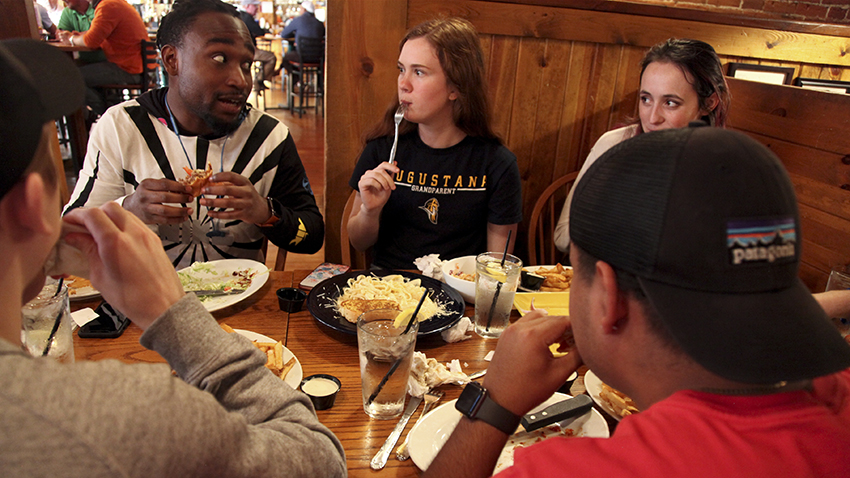 Students enjoy a meal off campus