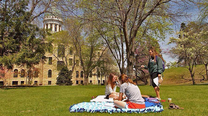 Students relaxing in the quad on a sunny day. 