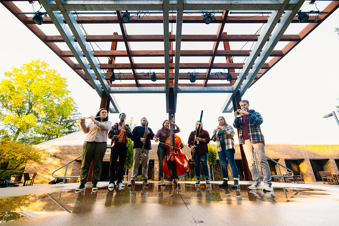 Students with instruments at the anderson pavilion. 