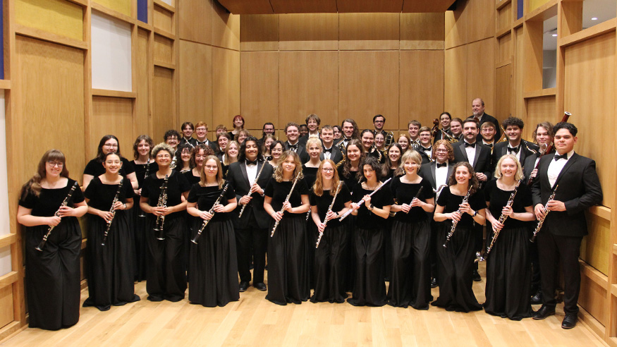 2026 group photo of the Augustana Symphonic Band, dressed in concert black attire