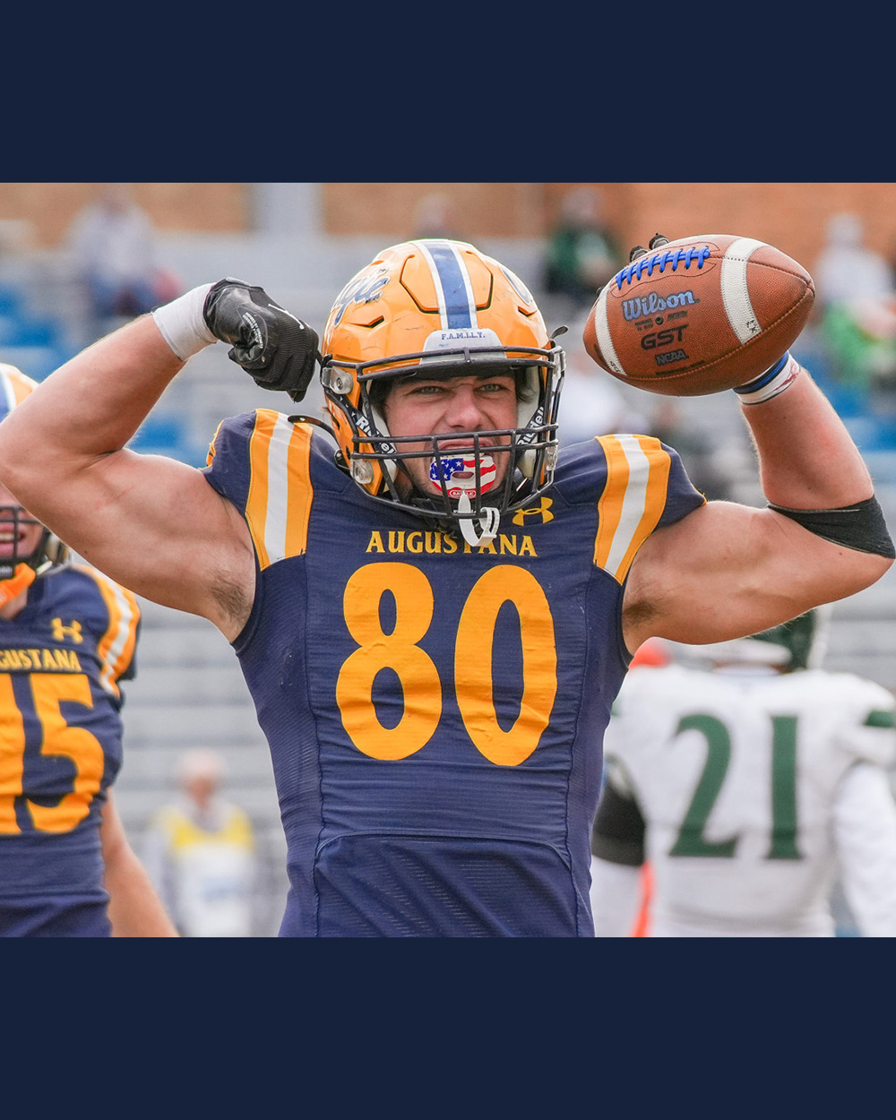 Augustana football player flexes while holding a football