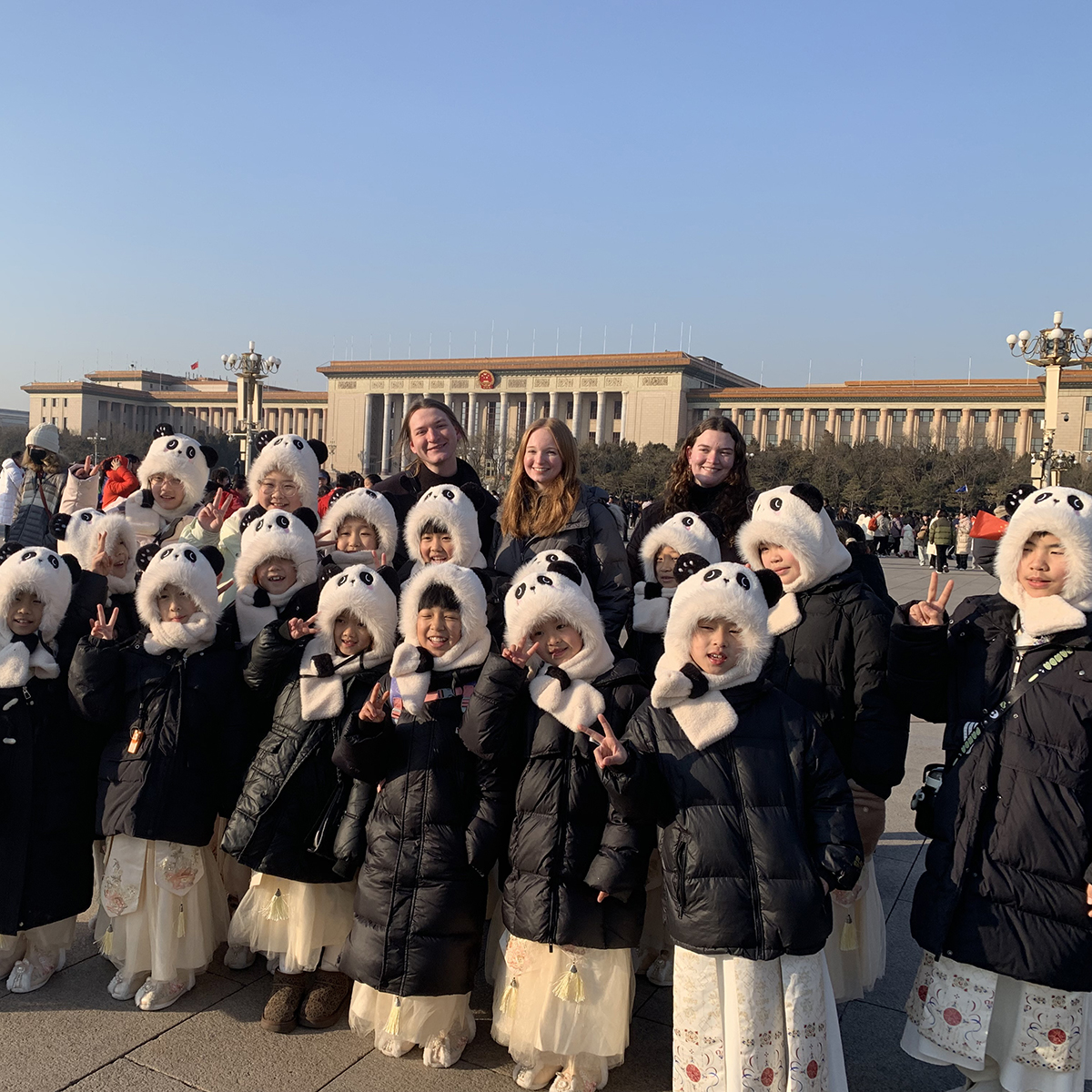 A group of young students in matching panda coats