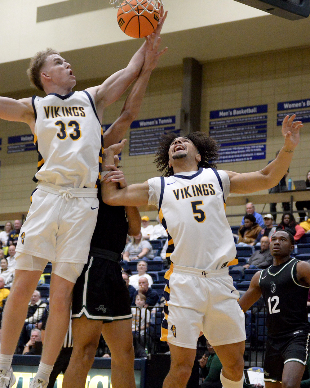 Basketball players jumping for a shot in a game