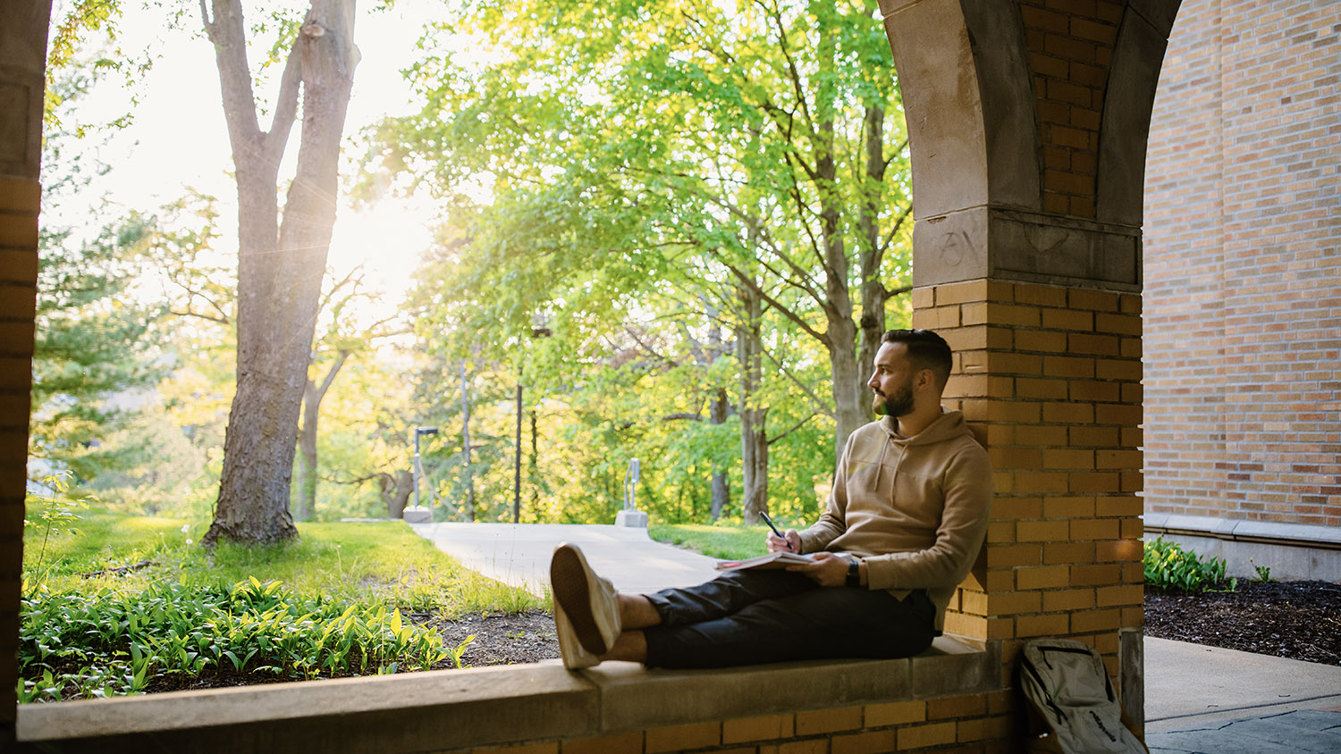 A student relaxing in the arches