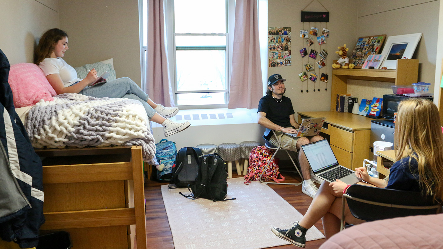 Three students in a dorm room