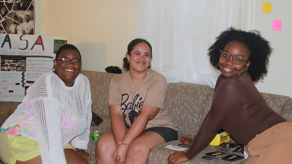 Three students pose