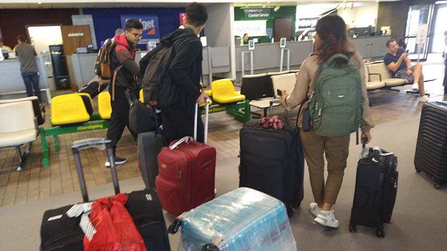 Students at airport with luggage