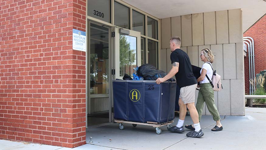 Student pushing cart.