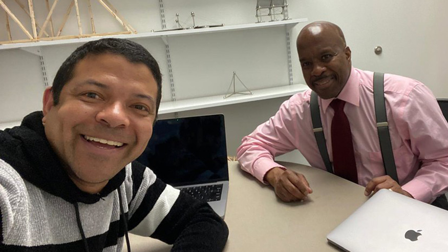 Augustana faculty member José Wilches and guest speaker Paul Guèye pose for a picture
