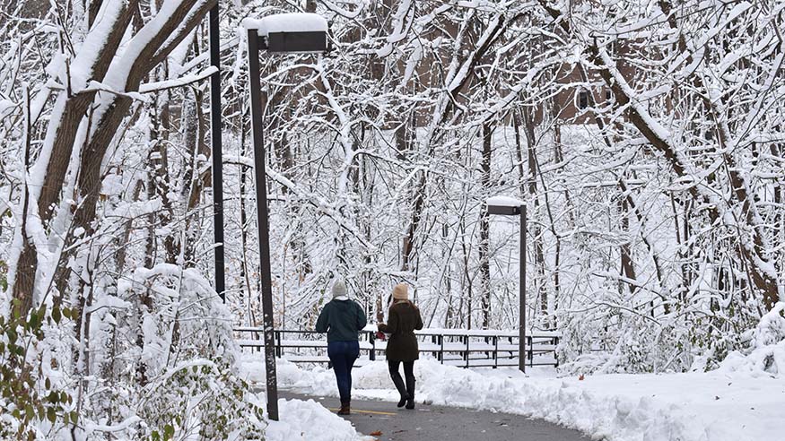 Students walk along Slough Path in winter.