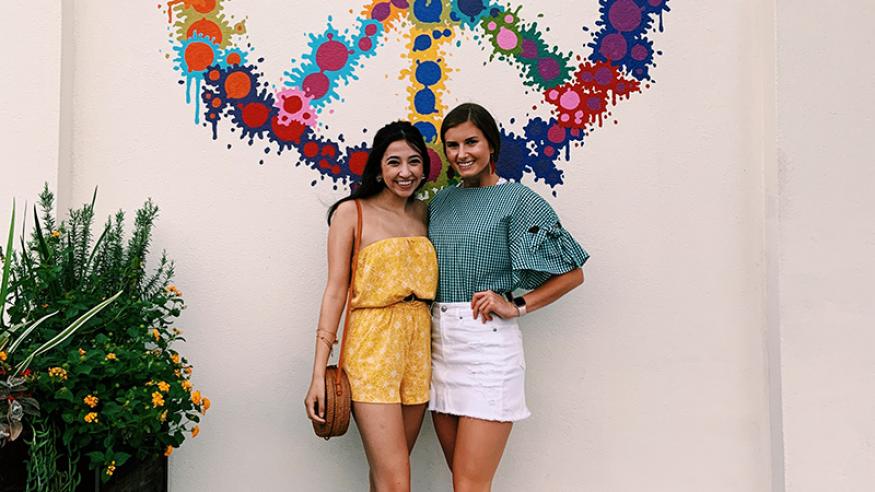 Brittany and Marisa in front of mural in Texas