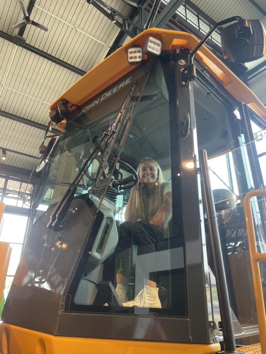 Jenny in a tractor at the John Deer Pavillion