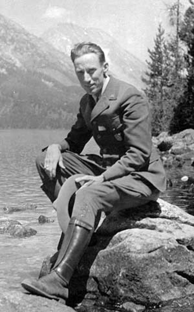 Fritiof Fryxell sitting on a rock in the Grand Tetons.