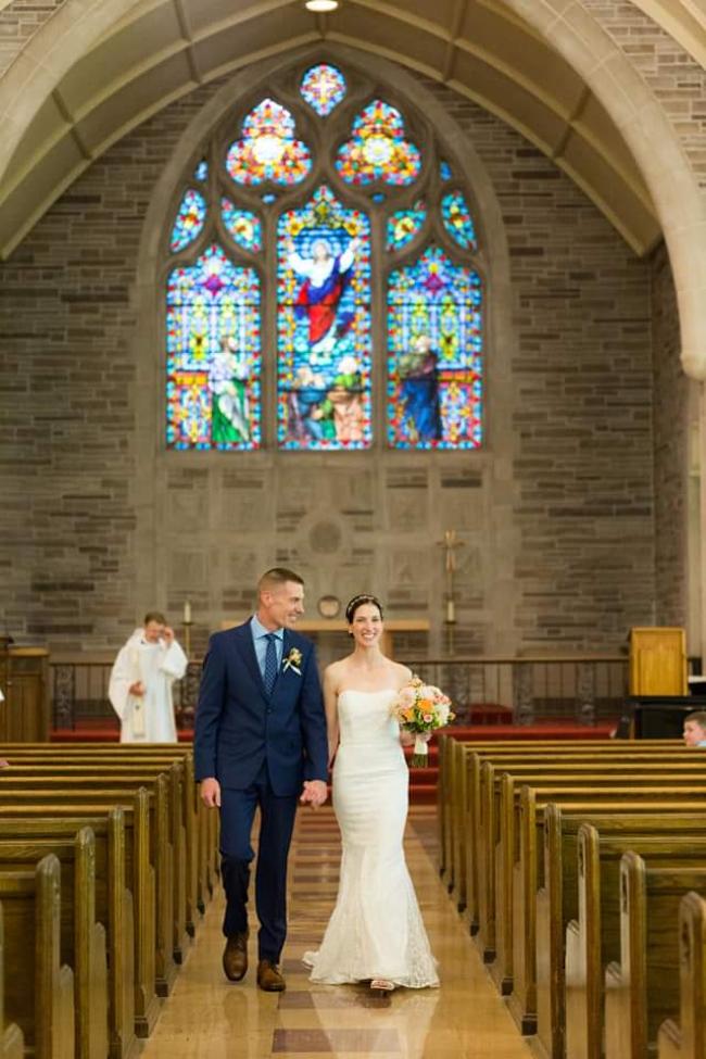 Jason on the left and Allison on the right walking down the aisle after they just got married
