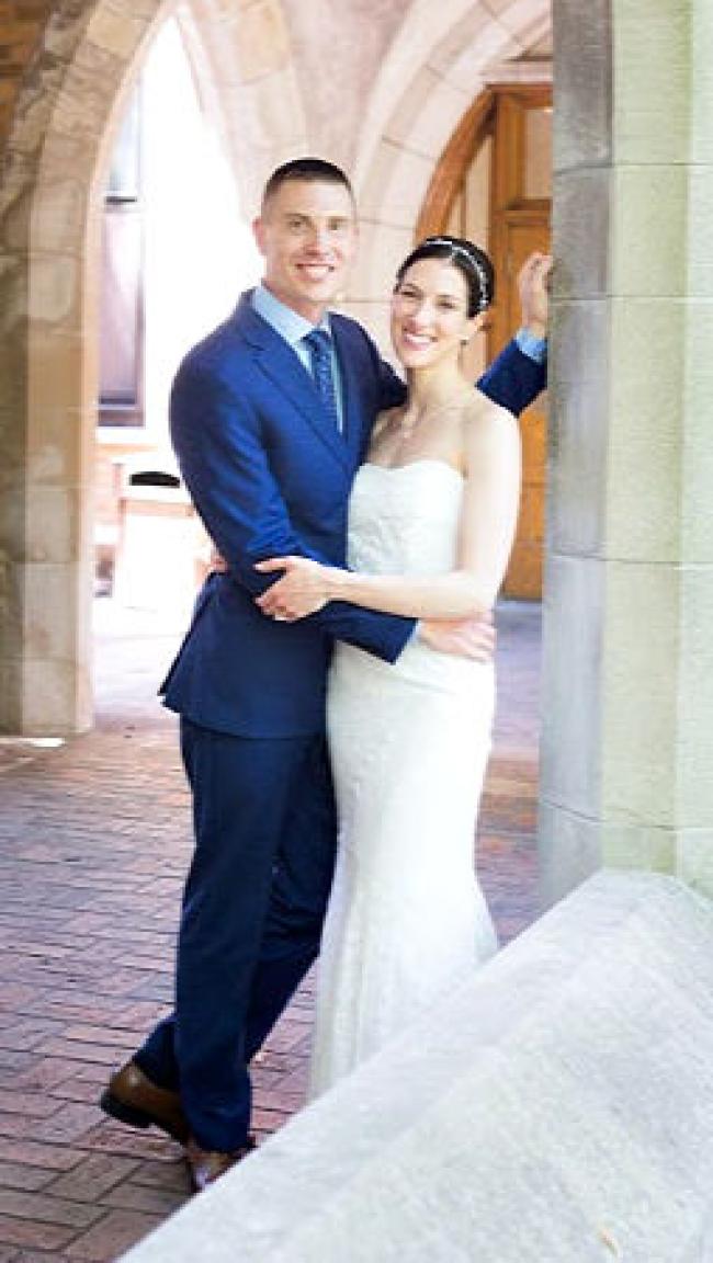 Jason (husband) on the left wearing a blue suit and Allison ( wife) on the right wearing a white gown