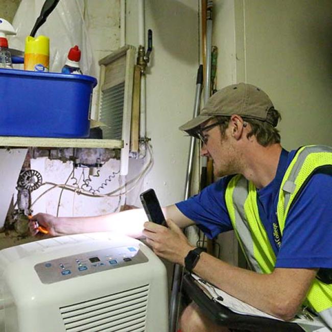 Student checking a service line