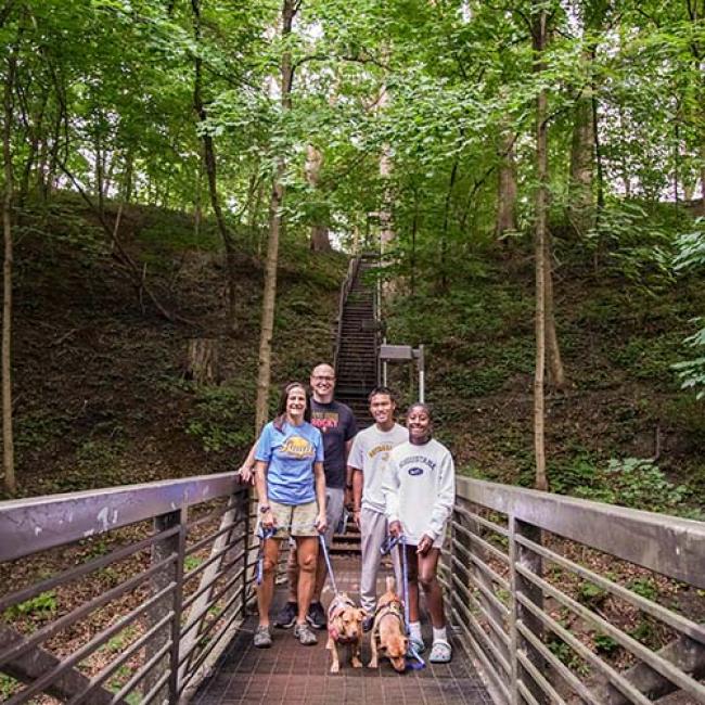 President Andrea Talentino and her family on a bridge that crosses the Slough