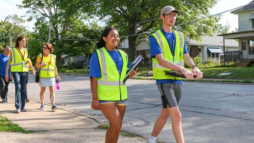 Augustana student research assistants Adriana Reyes and Erik Bergren canvassing Rock Island neighborhoods. 