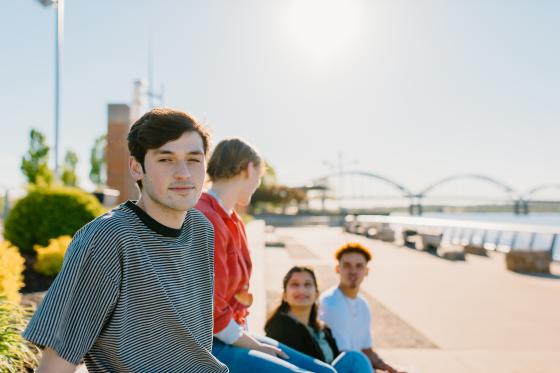 Students relaxing outside near the Mississippi River.