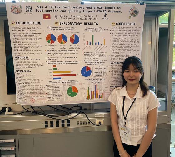 Student Standing in front of research poster